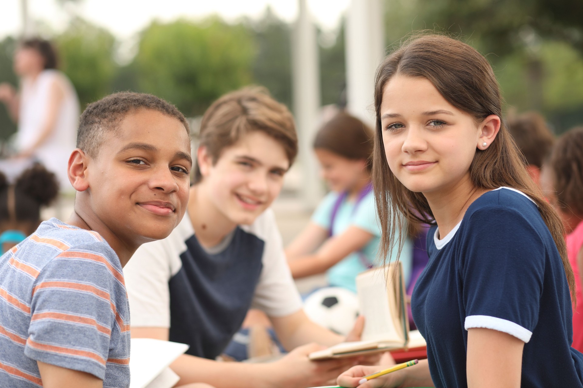 Group of junior high school children, teenage friends studying on campus.